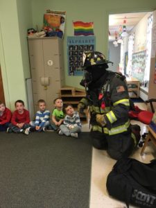 Fire fighter talking to children